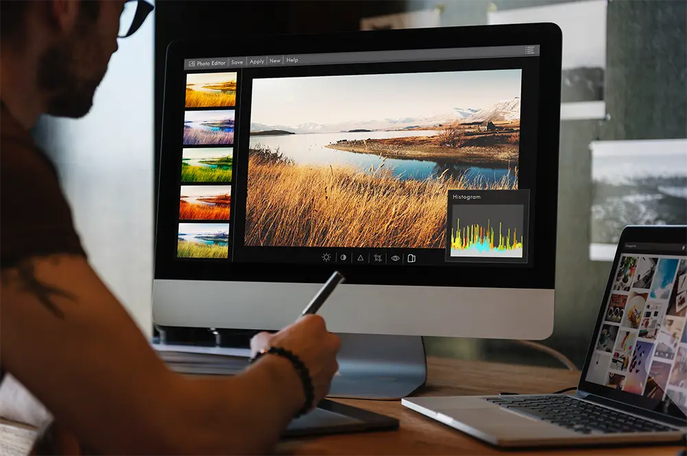 The Art Of Storytelling In Photography Marketing 2 a person using a computer to edit a picture. the person appears to be using photo editing software to make adjustments to the image, such as changing the color, brightness, and contrast.
