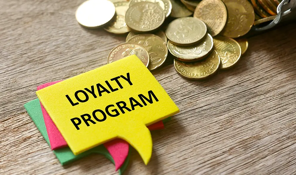 Building Customer Loyalty For Your Business 2 a hand holding a mobile phone with a loyalty program application on the screen.